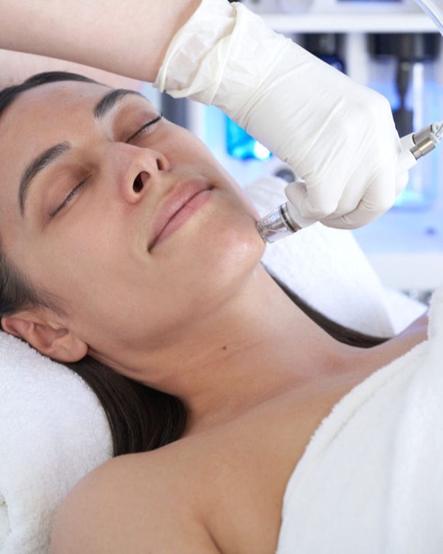 A woman getting a DiamondGlow facial.